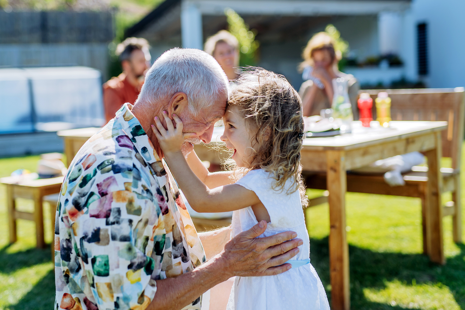 Happy Little Girl Embracing Her Grandfather At Generation Family